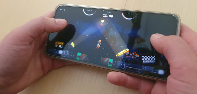 Smartphone in Hands with Space Tournament running